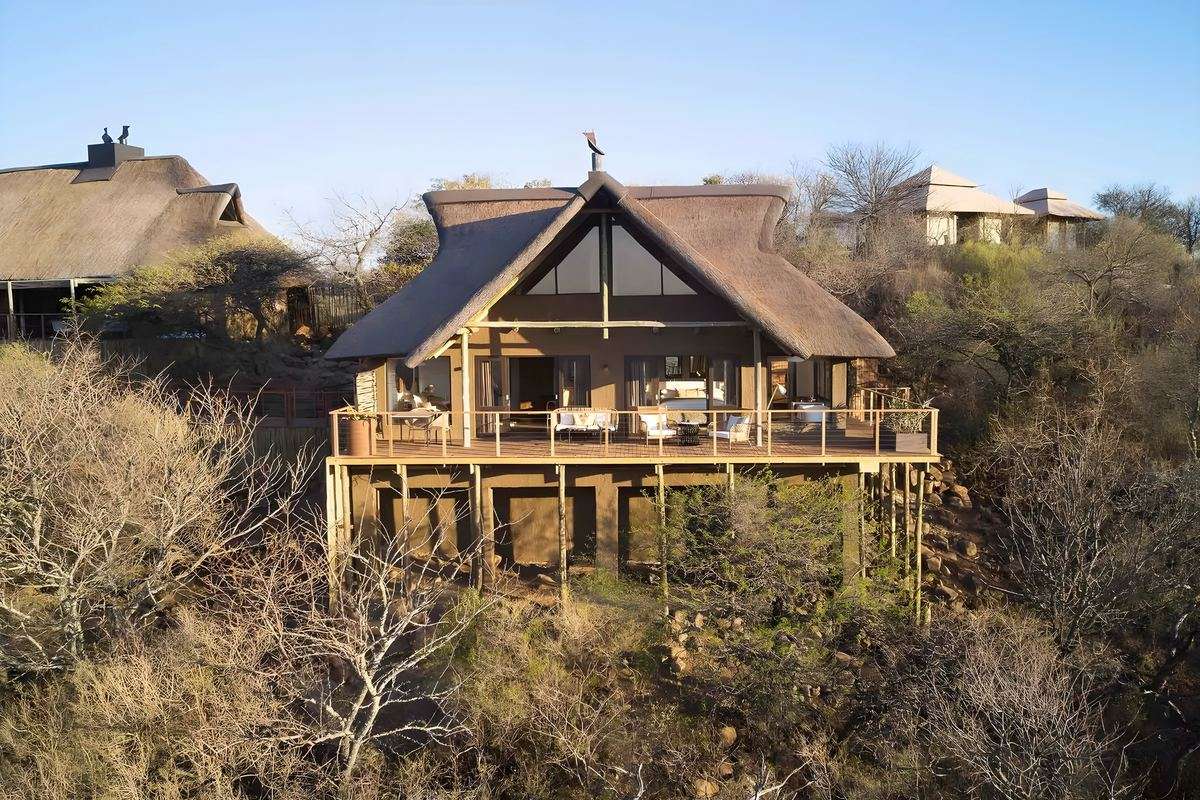 A thatched suite standing on stilts above the valley