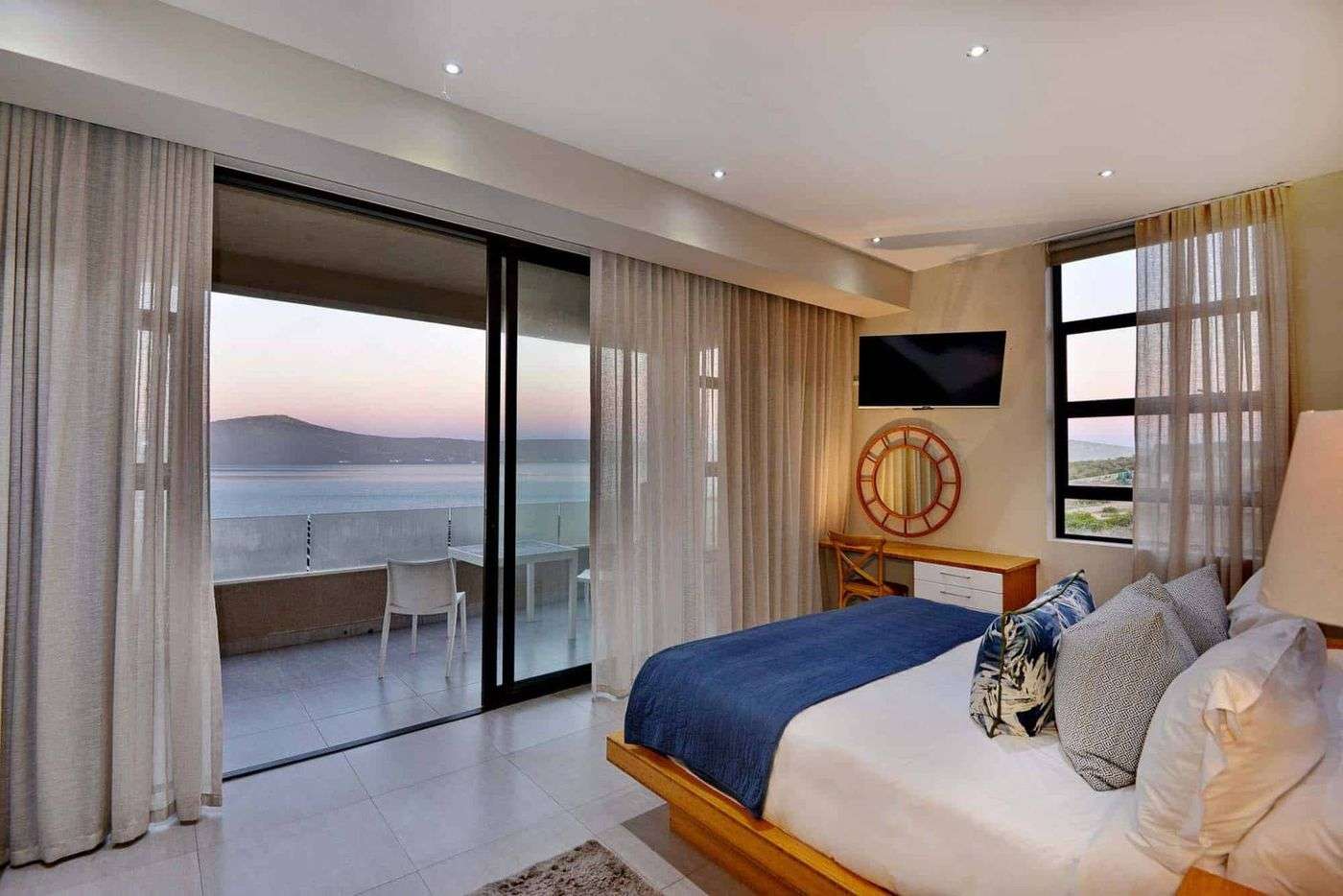 An Executive Room with its balcony over the lagoon at dusk
