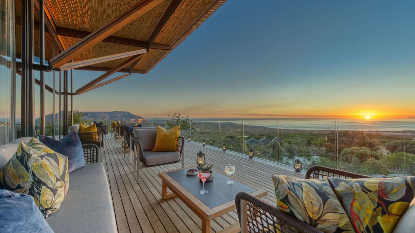 The deck at Grootbos Garden Lodge at sunset, looking over the fynbos to the sea