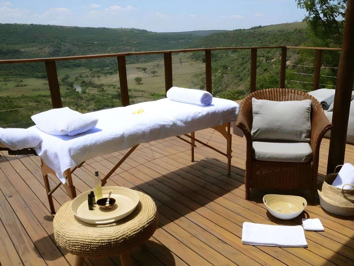 A massage table set up on a deck above the valley