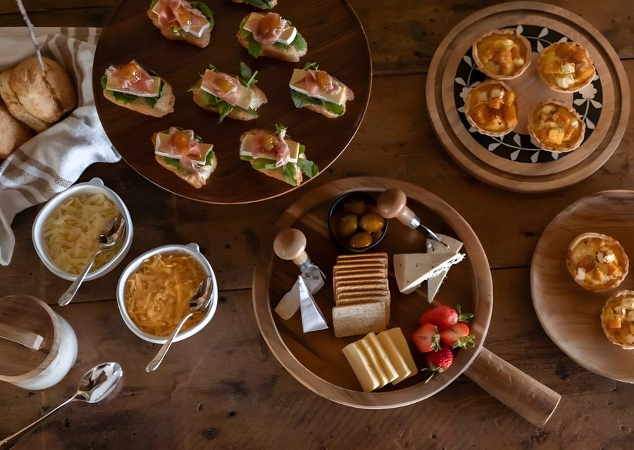 Afternoon tea of savoury tartlets, cheeses and filled rolls