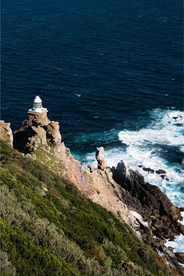 The new Cape Point lighthouse on a rock pinnacle above the surf
