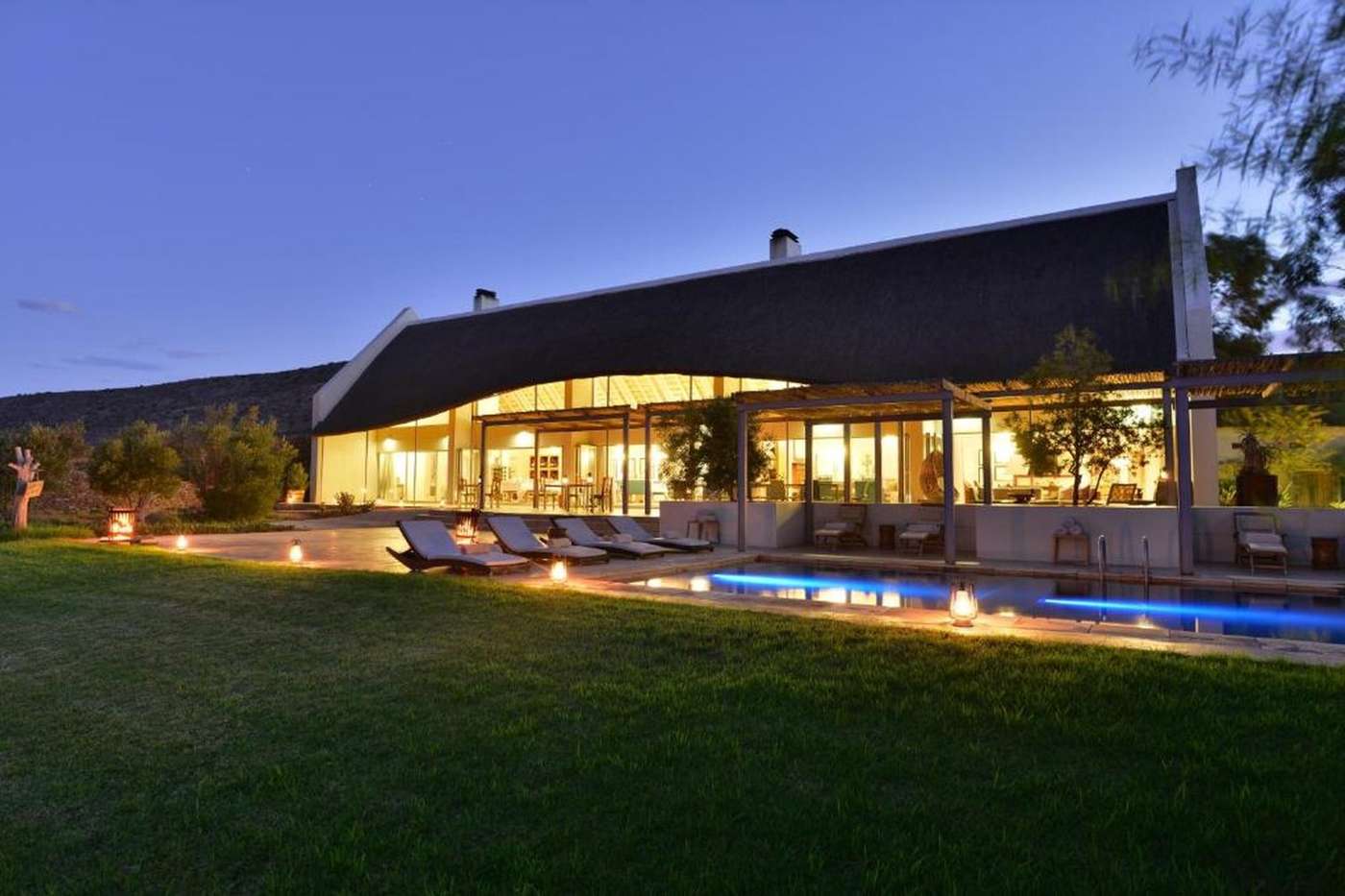 The family lodge at dusk, with the lawn and pool