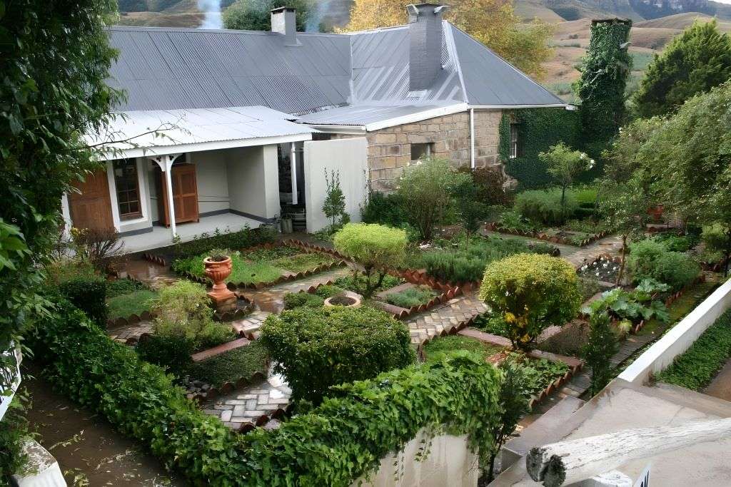 The walled garden and farmhouse with the mountains behind