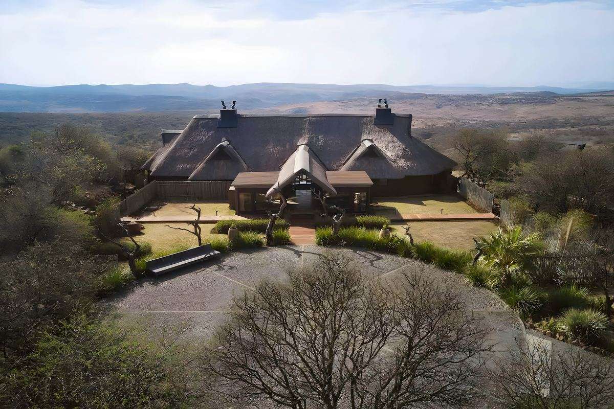 The thatched main lodge from the air, with the reserve stretching away behind