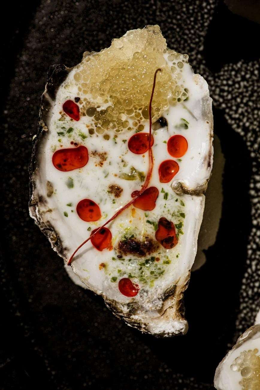 Oysters on the half shell dressed with pomegranate and herbs