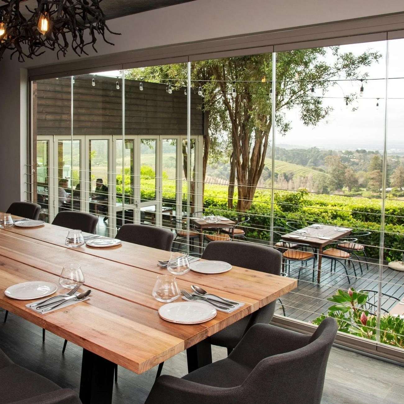 A private dining room with a long table beside the windows