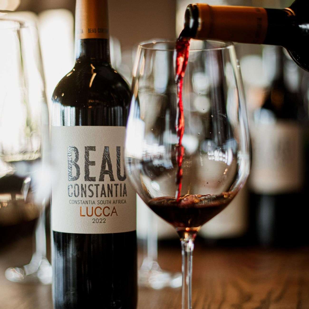 A bottle of Beau Constantia wine being poured into a glass