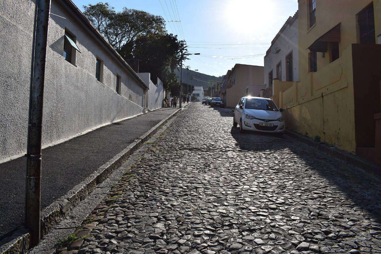 A narrow cobbled lane between walls in the Bo-Kaap