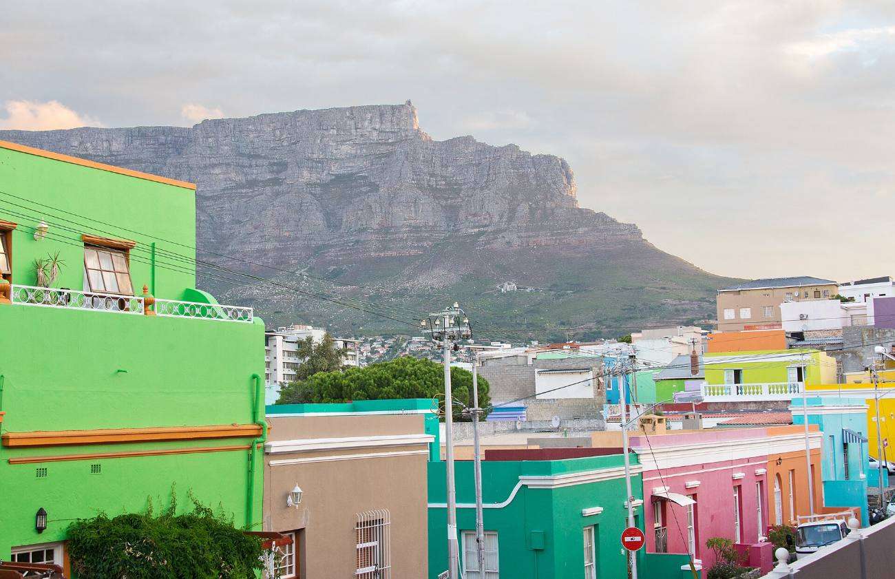 Brightly painted Bo-Kaap houses with Table Mountain rising behind them