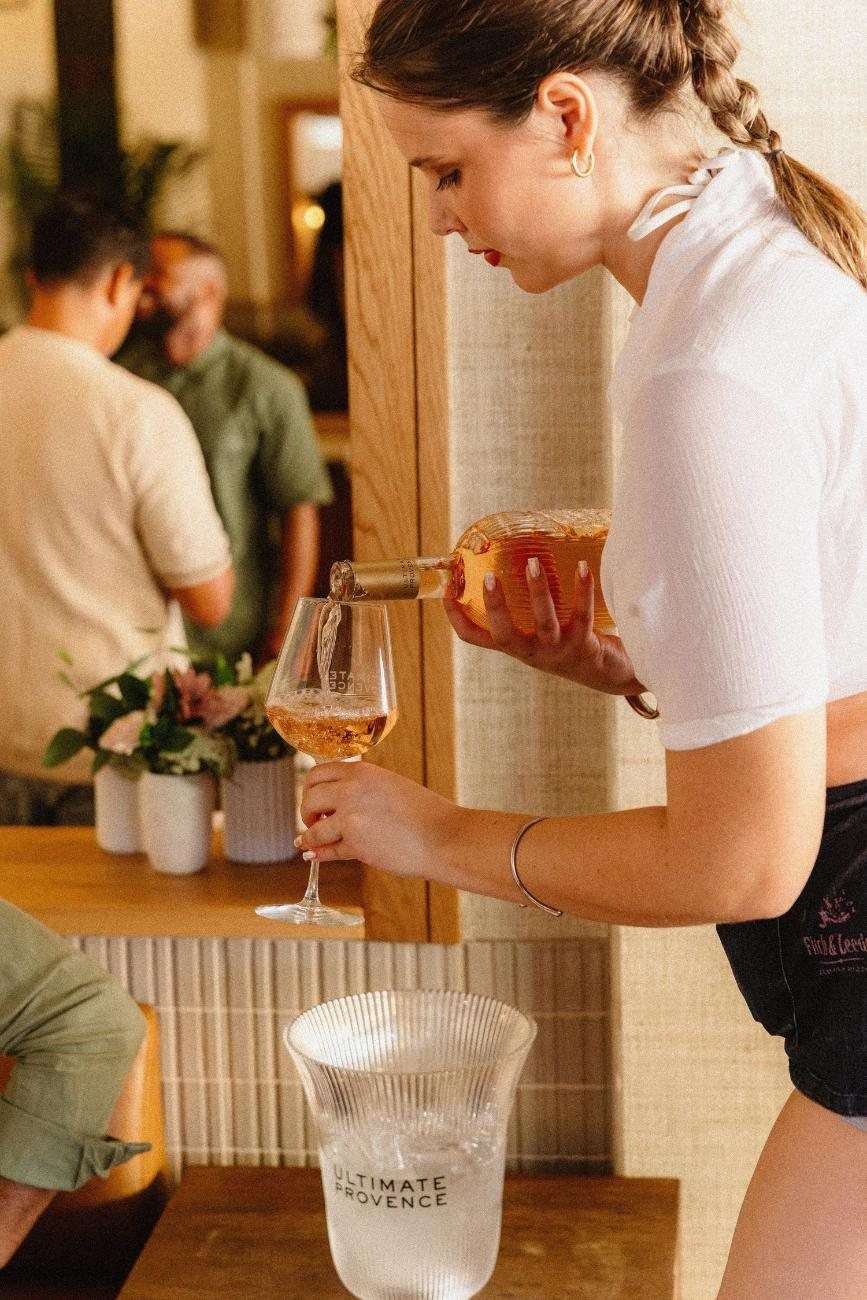 A waitress pouring rosé at the table