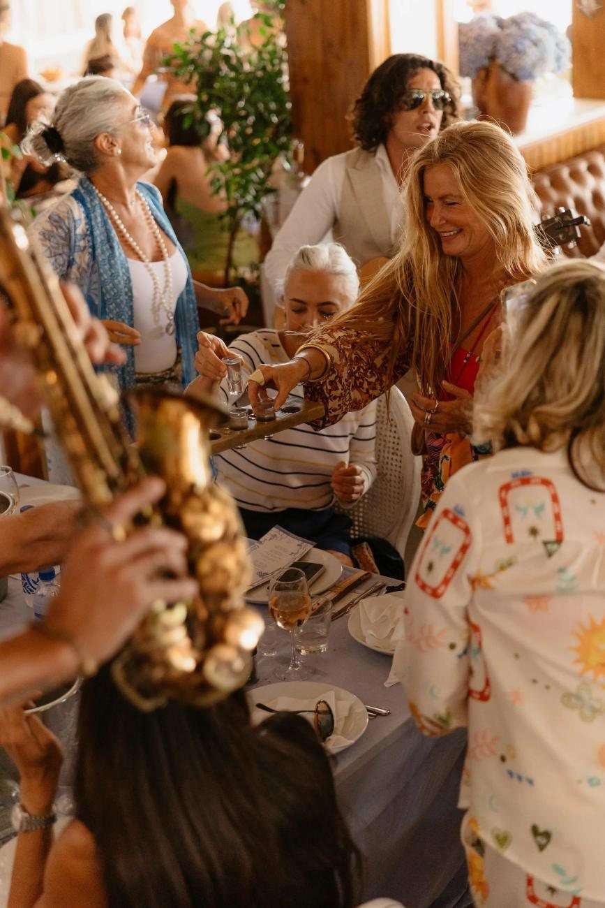 A saxophonist playing among the guests