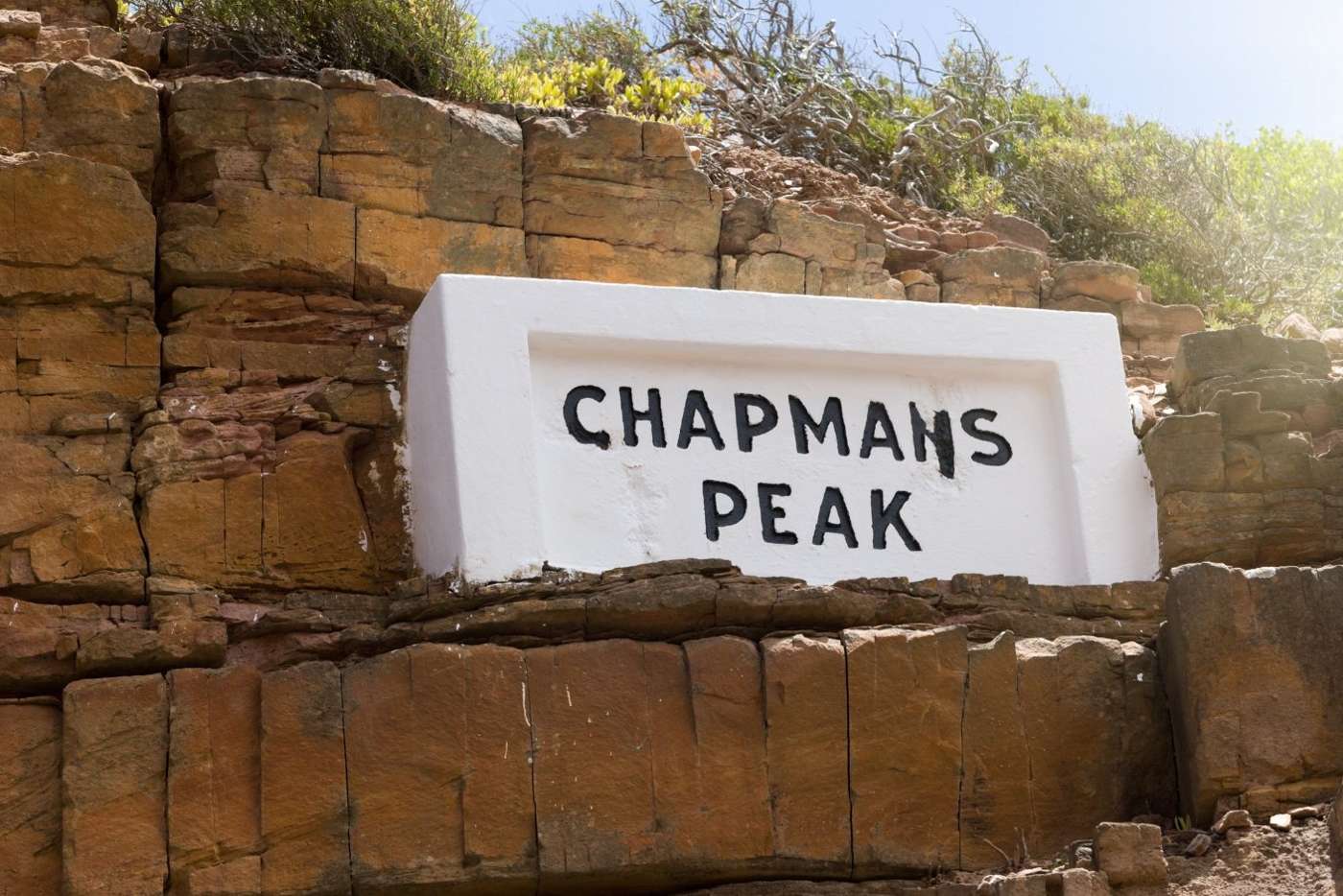 The painted Chapmans Peak sign set into the sandstone