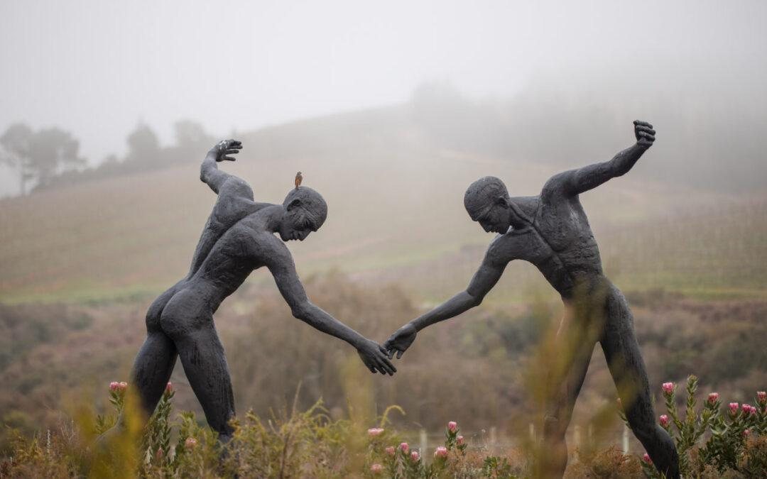 Two bronze figures holding hands in the mist