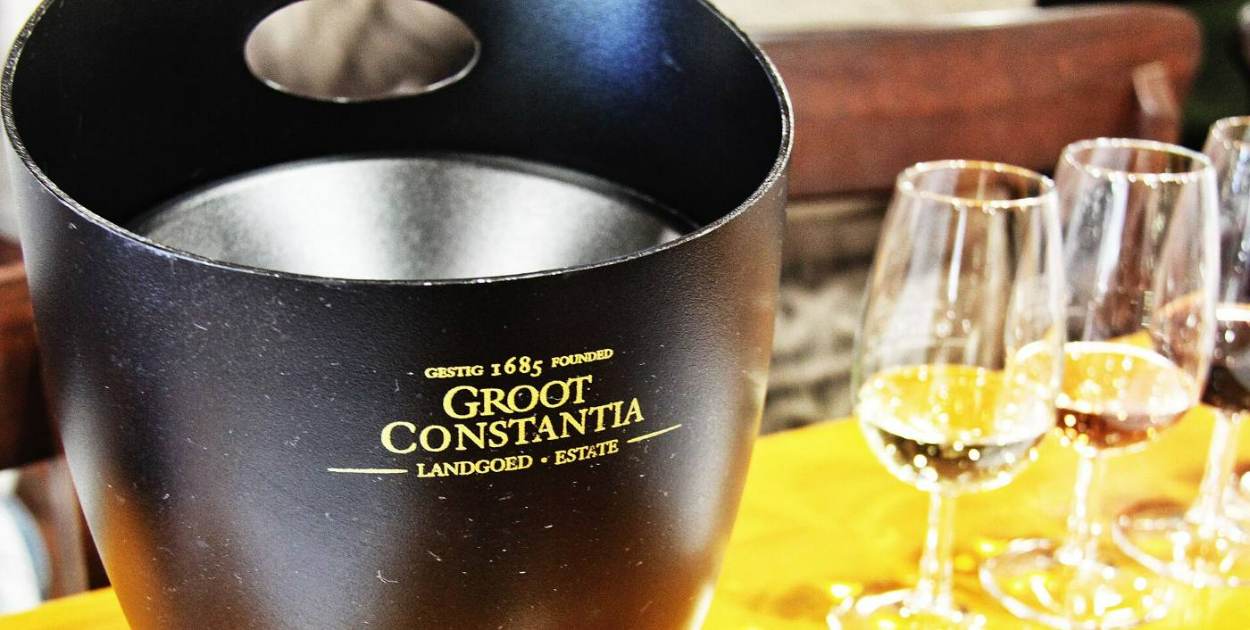 Glasses of wine beside a Groot Constantia wine bucket