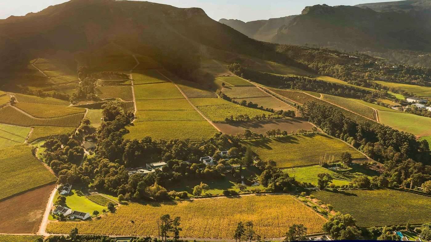 The Klein Constantia vineyards and the Constantia Valley from the air in late light