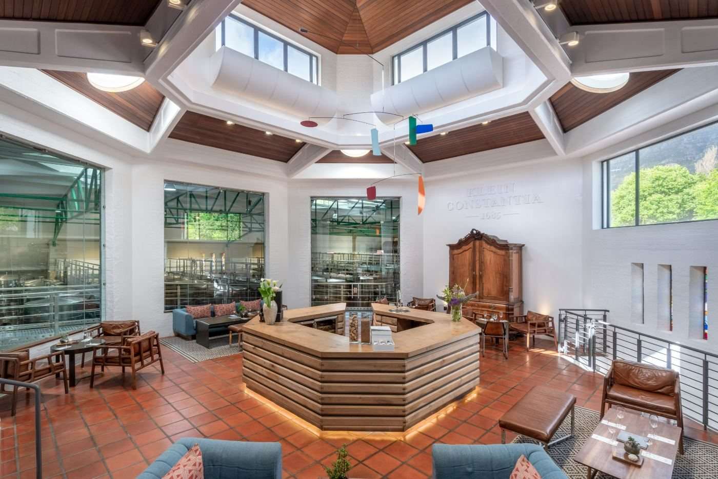 The light-filled tasting room at Klein Constantia with a central bar and terracotta floor