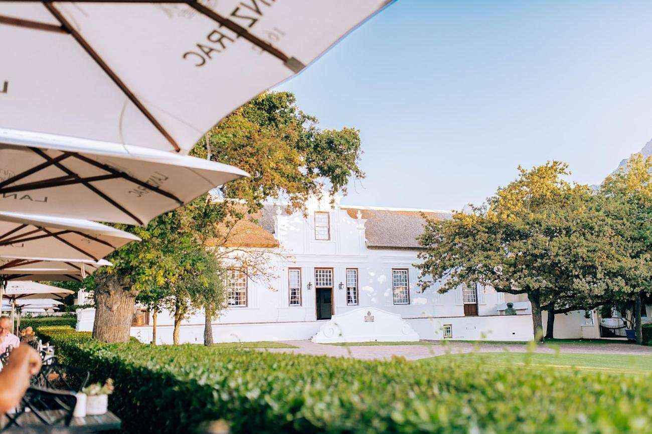 The Manor House lawn and white umbrellas on a summer's day
