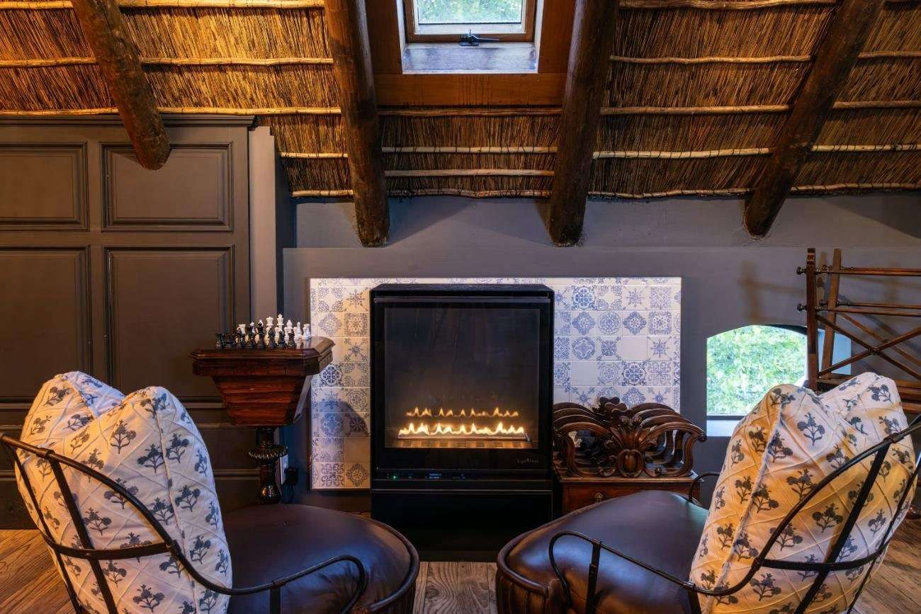 The Tasting Room with armchairs around a fireplace