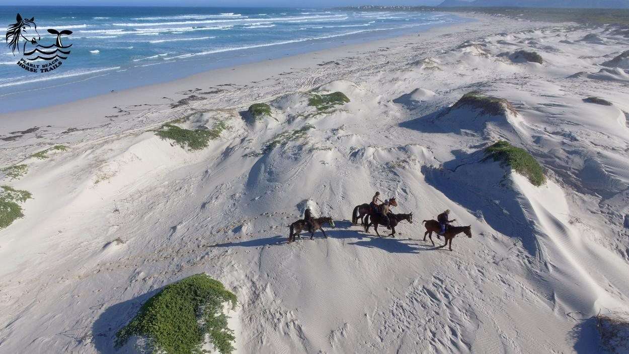Riders crossing the white dunes seen from the air