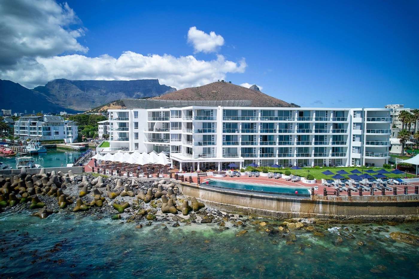 The Radisson Collection hotel on the rocks at Granger Bay, with Table Mountain behind
