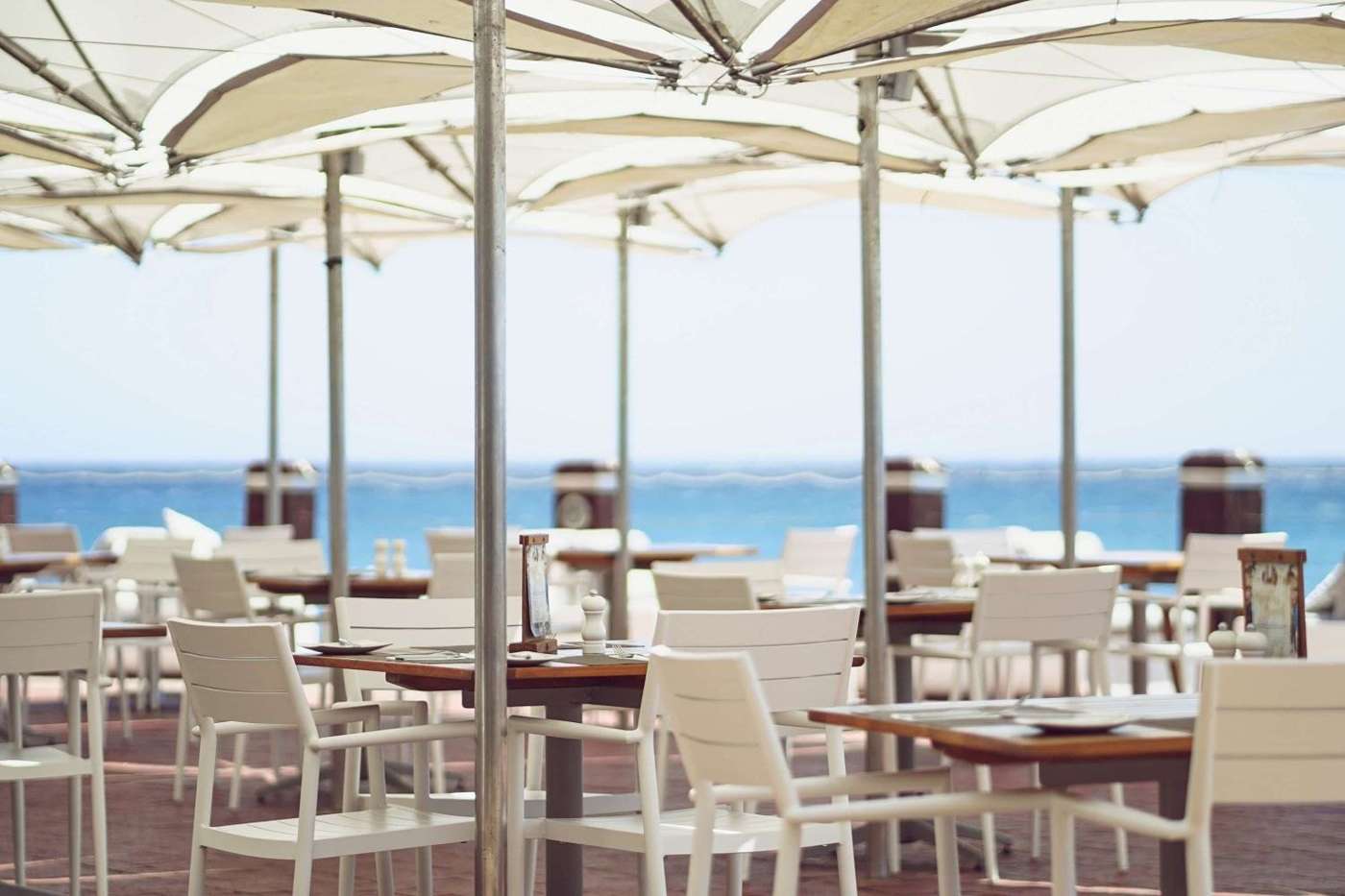 Tobago's terrace with white umbrellas above the sea