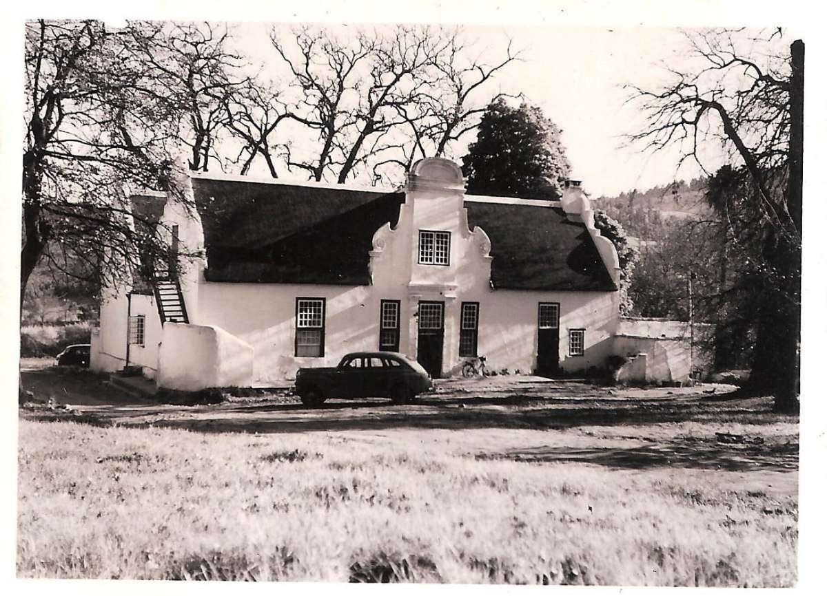 A black and white photograph of an old Cape Dutch farmhouse