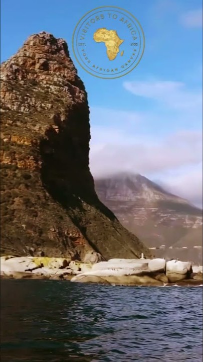 The cliffs of the Sentinel above the rocks of Seal Island, seen from the boat