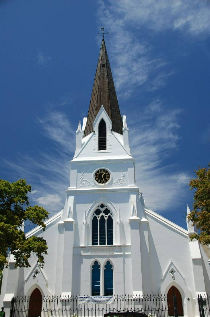 The tall white spire of the Dutch Reformed mother church against a blue sky