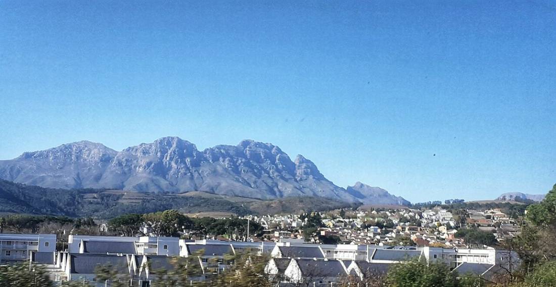 Rugged blue mountains above the white rooftops of the town