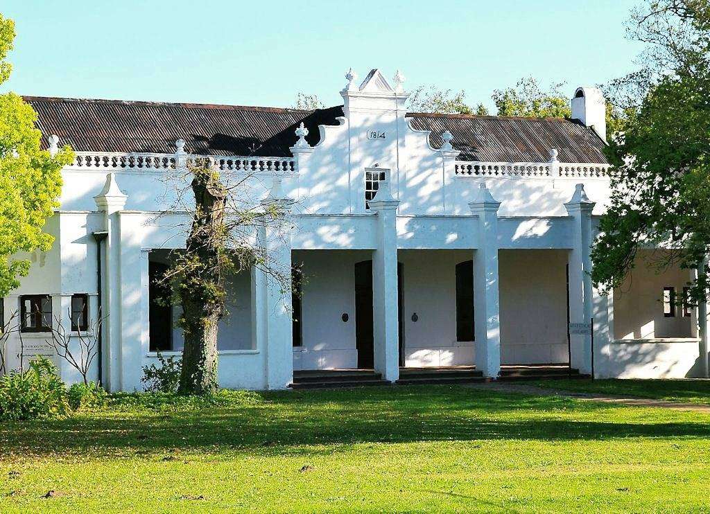 A whitewashed Cape Dutch house with a gabled front on Dorp Street